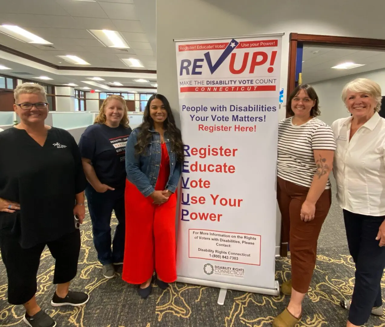 Voting Rights Clinic photo of Wendy and others by a banner