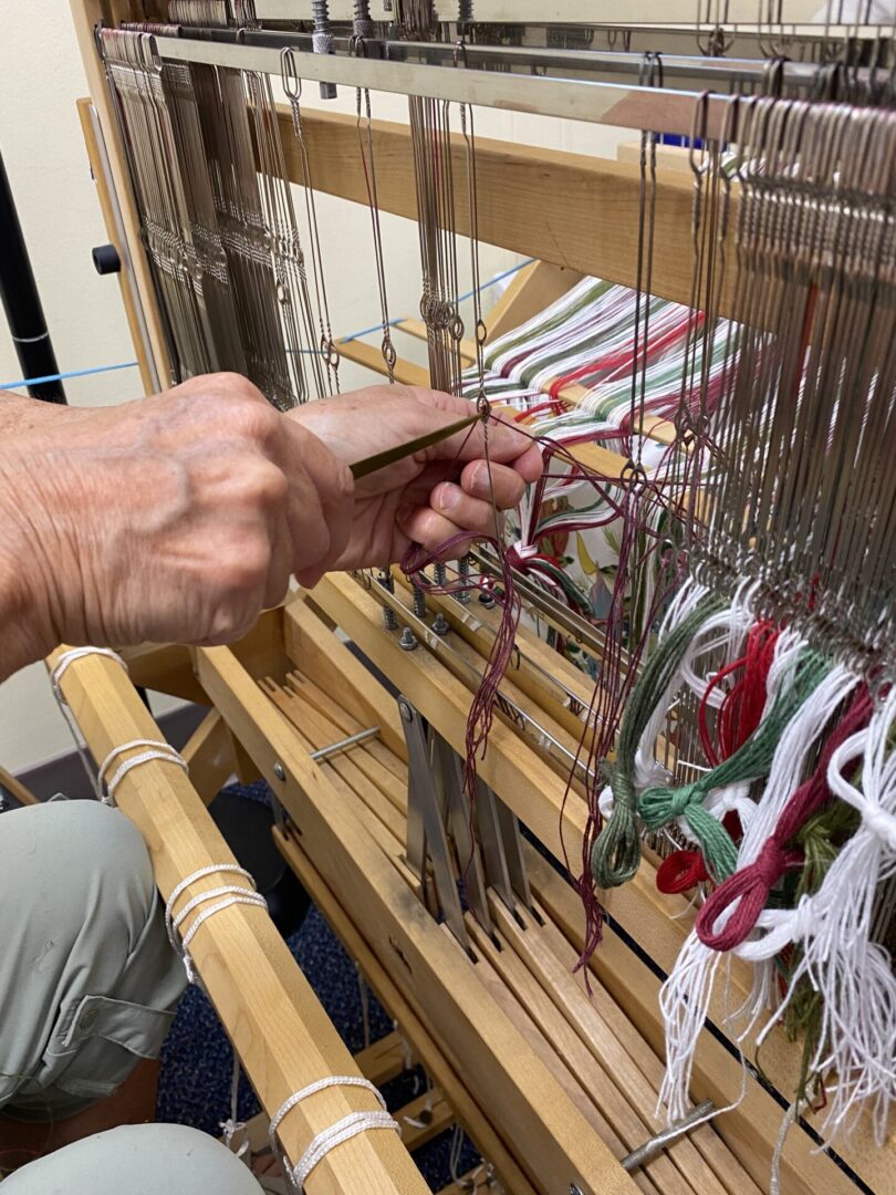 A closeup of threads on a loom