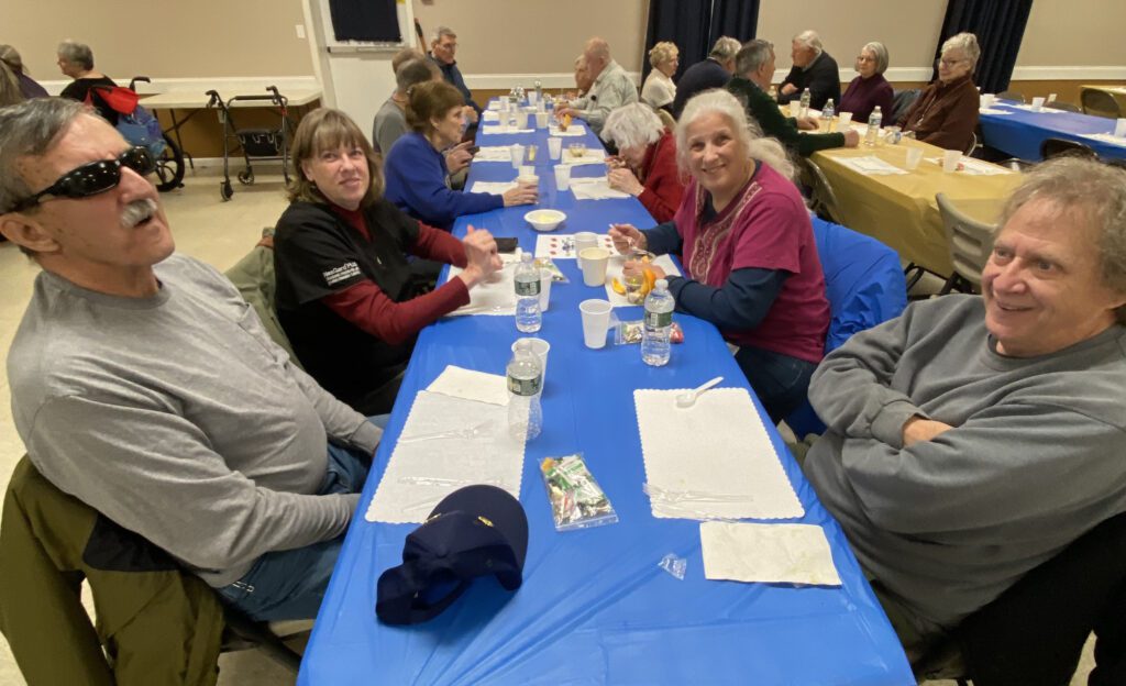 A table full of members socialize before dinner.